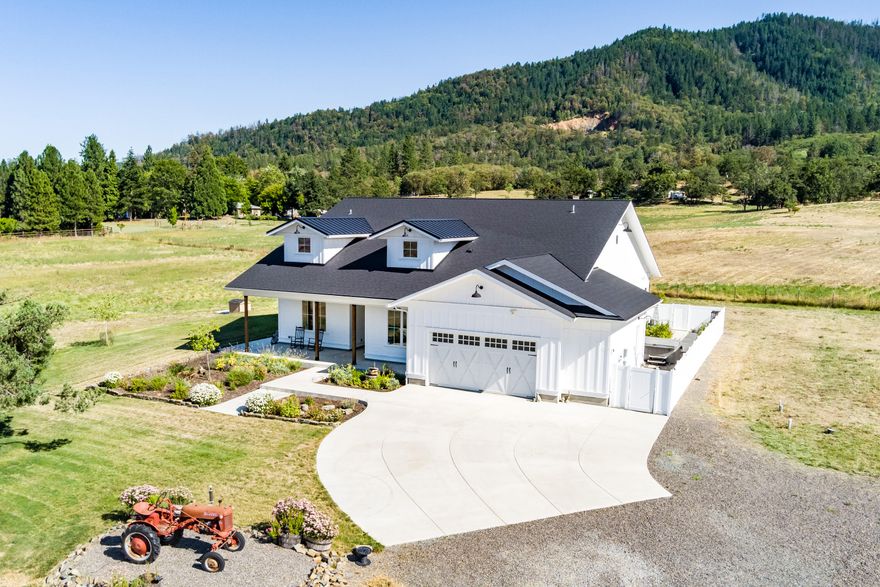 Stunning, Steve Asher built modern day farmhouse on 5 pastoral acres. Earth Advantage & Energy Star certified with every attention to detail; vaulted ceilings, gorgeous hardwood floors and custom cabinets throughout. The kitchen is equipped with stylish Quartz countertops, stainless appliances, farmhouse sink, large kitchen island w/ bar seating & walk-in pantry. Open great room with incredible natural light, propane fireplace w/stone surround & large picture windows. Owner Suite is nicely separated from the other bedrooms, has a gorgeous bathroom w/ free-standing tub, tiled shower & roomy closet. In addition to 3 bedrooms there is also a den for overflow living/office. Seasonal creek, water catchment holding tank for landscaping irrigation plus a strong well last tested at 20+ gpm. Whole house filter, UV & RO systems. Fully fenced w/ gated entry, solar, 400 Amp service and electric car charger. Detached shed/office, hot tub, dog run and views in every direction.