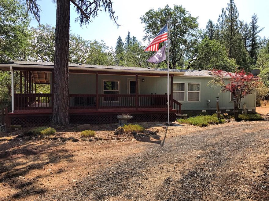 Private park setting at the end of Drake Road. This 1512 square foot, 3 bedroom, 2 bath top of the line Palm Harbor home has been well cared for with many recent updates. Property is fully fenced with a separate fenced garden area and fenced backyard. The exterior of the home boasts a new painted wrap-around redwood deck and screened-in patio. The detached oversized 2 car garage has been recently updated with a 24x32 attached shop/work area for a total of 1440 square feet between garage and shop area. Other recent upgrades include a 2nd well that has been recently drilled, new roof on both home and garage, new HVAC system with warranty that will pass to new owners. This home is ready for it's new owner! Well flow is 8.71-GPM per seller with a 1,500 gallon in-ground holding tank. Septic was pumped and serviced in August 2019.