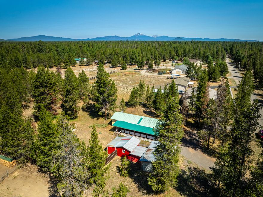 Affordable opportunity on 1.11 fully fenced acres in La Pine! This property features a mobile home surrounded by mature trees, an expansive covered porch, multiple storage sheds, a workshop, carport, and an RV hookup with dump, ideal for guests or your own RV adventures. The septic tank was replaced in 2004, and there's an immaculate well pump house for added peace of mind. The spacious lot offers room to expand or build your custom home. Enjoy privacy and versatility with close proximity to lakes, trails, and outdoor recreation. A rare find with incredible potential! Financing available!