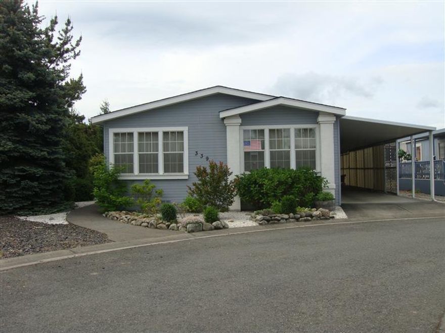 Well cared for manufactured home with 12'x 12' shop. 1512 sqft 2 bdrm, den and 2 bath home built in 1990. Living room is light and bright, kitchen has oak cabinets and loads of counter space. Formal Dining with wall for hutch or desk, laundry room with room for freezer. Master has walk in closet, master bathroom has built-ins, shower and double sinks. House has newer carpets. Dishwasher has been replaced and home has a new roof. Most of the plumbing has been redone w/ copper pipes. Two sky lights add natural lighting. Tandem 2 car carport.