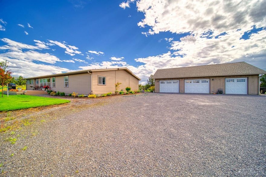 Newer 2800 sq ft triple wide overlooking 155 acres with a full pivot and a 15,000 sq ft steel hay storage. Beautiful home with lots of upgrades, open kitchen and formal dining area with plenty of windows, large master suite, laundry/mud room and office space, big deck and detached garage fully finished.