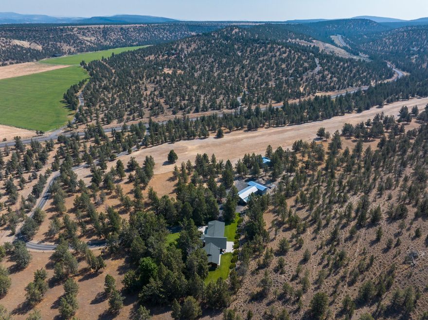 Custom home, shop, hanger, grass field/airstrip on 41 acres with 26 acres of ground water rights (well). Airstrip has been hayed in the past and could easily be converted to pasture. Ranch style home is single level, 2198 sq ft, 3 bedrooms, 2 bathrooms, open floor plan and quality finishes throughout. Chef's kitchen with breakfast bar, pantry and granite countertops. Dining area and large living room with vaulted ceilings and wood burning fireplace easy for entertaining. Terrific outdoor living with covered deck, patio and landscaped yard with sprinkler system. Two car garage attached with breezeway. Shop includes two storage rooms, 3 bays and an RV bay. The setting is private, close to town and about 15 minutes from Prineville Reservoir.