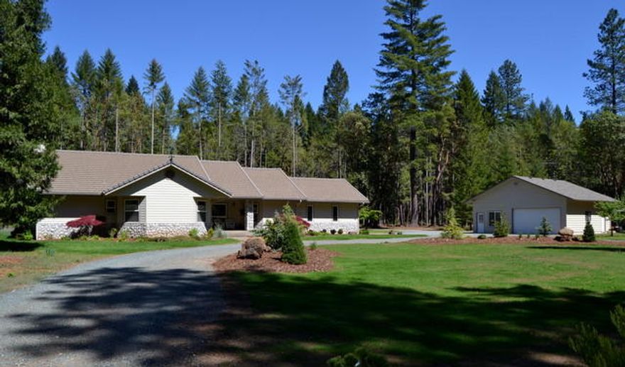 Amazing Country Property! Home is located on over 5 acres in a quiet neighborhood of custom homes. This home has been completely updated inside & out within the last two years. Beautiful New high end granite kitchen counters and bath counter. All new stainless appliances. New flooring which includes hardwood, tile and carpet. New exterior paint and a wonderful new deck to enjoy those beautiful summer evenings.Two car attached garage and a two car detached garage which also features a bonus room currently being used as an exercise room but would also make a fantastic art studio or hobby room. Covered RV parking. Over $17,000 in new fencing which includes the rod iron gated entry with keypad. All level land which would be great for horses, a garden or whatever hobby you may enjoy. Fantastic location, quiet country living only 10 mins to shopping, restaurants and 45 mins to the beach. Some properties have it all and this one does. You must tour to appreciate.