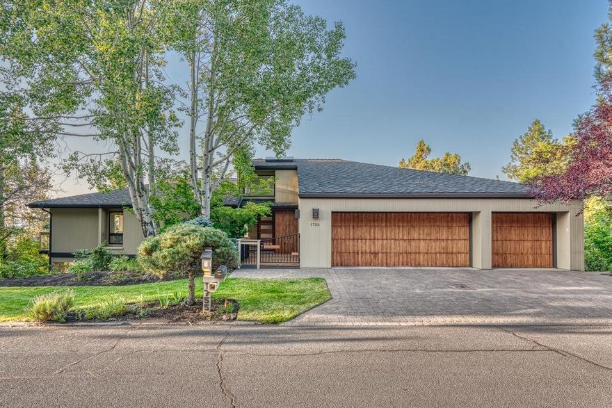 Casual luxury abounds in this Northwest Contemporary home located in Bend's classic West Hills addition. Custom built to capture the spectacular panoramic views offered by the southwest hillside setting & expansive cedar decking. The interior great room is a light filled sanctuary with vaulted wood ceilings, and huge picture windows that bring the outside in. The large gathering room highlighted by a wood burning fireplace merges  seamlessly with the kitchen and dining room. The well planned kitchen offers stainless appliances including Viking double ovens & island cooktop, breakfast bar, built-in desk and under cabinet windows for extra natural light.  Main level primary suite with two walk-in closets and his & her bathrooms. Lower level provides two bedrooms, hobby room w/shelving and oversized media/game room with built-in wet bar and mini fridge.  Level driveway and an oversized triple garage with stairway access to a large attic space.  Put this one on your must see list!