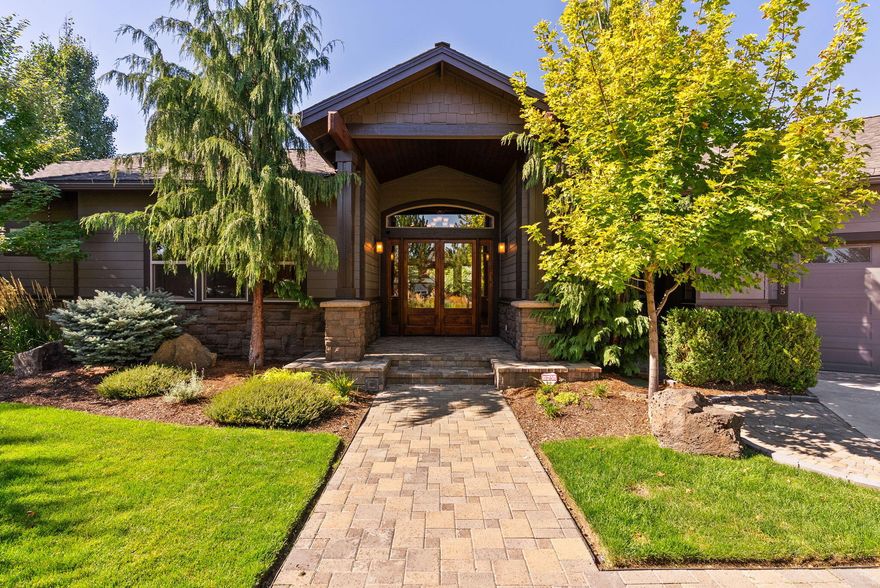 Tucked at the end of a quiet cul-de-sac, this custom single-level 3,158 sq ft home rests on a manicured 0.5-acre lot surrounded by mature landscaping. Designed with three en suite bedrooms and four bathrooms, it features a versatile office/den, chef's kitchen with two full refrigerators, an under-counter double-drawer fridge, ice maker, and trash compactor. The private primary suite offers a soaking tub, tiled walk-in shower, dual enclosed toilets, double sinks, makeup vanity, and walk-in closet. The suite also includes an enclosed sunroom for year-round enjoyment. Additional amenities include built-in speakers, central vacuum system, heated 4-car garage with finished storage, indoor/outdoor dog run, gated RV parking, multiple paver patios, and covered outdoor living areas perfect for entertaining or relaxing in any season.