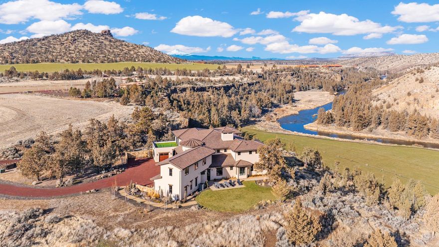 I am Painted Rock.
Nestled w/in the exclusive Ranch at the Canyons, I was created to honor both nature's grandeur & the bonds of family. Cradled by 2.5 miles of private Crooked River frontage, framed by the timeless cliffs of Smith Rock, I offer a sense of peace that few places can match—just 20 minutes from Redmond Airport, yet worlds away in spirit.
I've been home to two families—each one adding to my story, each one cherishing my views, my quiet mornings, & my golden sunsets over the canyon. I was designed w/ intention & heart, built to welcome more than one generation at a time. My main level holds two primary suites, each in its own private wing, allowing comfort & independence while still keeping loved ones close.
In my great room, walls of glass open wide to let the high desert light pour in, merging the warmth of my interior w/ the vast beauty beyond. I am a place where privacy meets connection, where laughter echos off canyon walls and Oregon's wild beauty is celebrated.