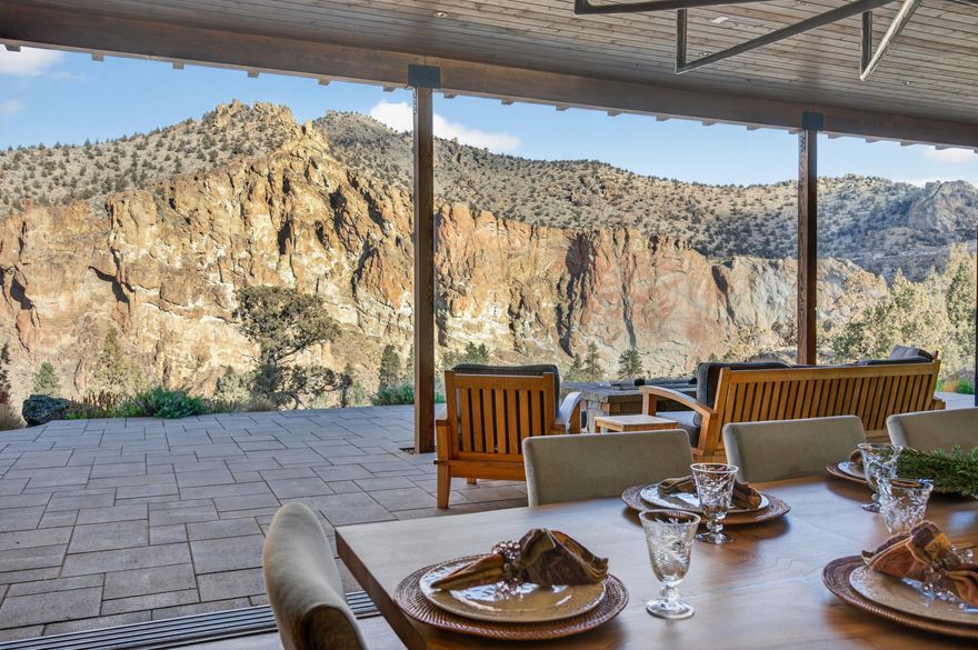 I am Painted Rock.
Nestled w/in the exclusive Ranch at the Canyons, I was created to honor both nature's grandeur & the bonds of family. Cradled by 2.5 miles of private Crooked River frontage, framed by the timeless cliffs of Smith Rock, I offer a sense of peace that few places can match—just 20 minutes from Redmond Airport, yet worlds away in spirit.
I've been home to two families—each one adding to my story, each one cherishing my views, my quiet mornings, & my golden sunsets over the canyon. I was designed w/ intention & heart, built to welcome more than one generation at a time. My main level holds two primary suites, each in its own private wing, allowing comfort & independence while still keeping loved ones close.
In my great room, walls of glass open wide to let the high desert light pour in, merging the warmth of my interior w/ the vast beauty beyond. I am a place where privacy meets connection, where laughter echos off canyon walls and Oregon's wild beauty is celebrated.