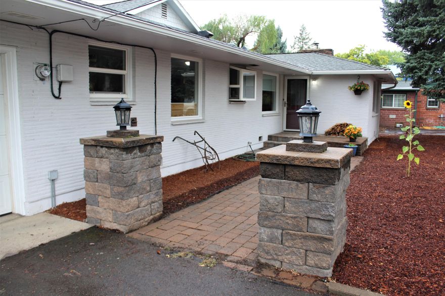 Beautifully updated & upgraded Home on 1 acre in town!  The Living Room features a large Picture Window, Pellet Stove, & Hardwood Floors. The updated Kitchen has Tile Floors, S/S Appliances, Gas Range with Double Ovens, Wood  Block Counters, & a Farmhouse Sink! The Pantry is expansive, and there is abundant Storage throughout the Home.  Central Air / Tankless Water heater.  Walk out to the Deck from the Primary Bedroom with a spacious ensuite Bathroom: Custom Tile & Heated Floors.  The Great Room with Vaulted Pine Ceiling takes you outside to the Covered Patio for outdoor enjoyment!  Over 1/2 acre remains for a Garden, Livestock or recreation.  The 22x32 Shop is Insulated with Power & Water - may be an ADU for additional income...?  A local farmer has been growing Farm to Table veggies for our Community on the land. The (3) Greenhouse Tunnels are included.  Brick & Hardi-Plank Siding, Vinyl Windows, Paved Driveway, RV Parking, Fruit Trees... This Property has so much to offer