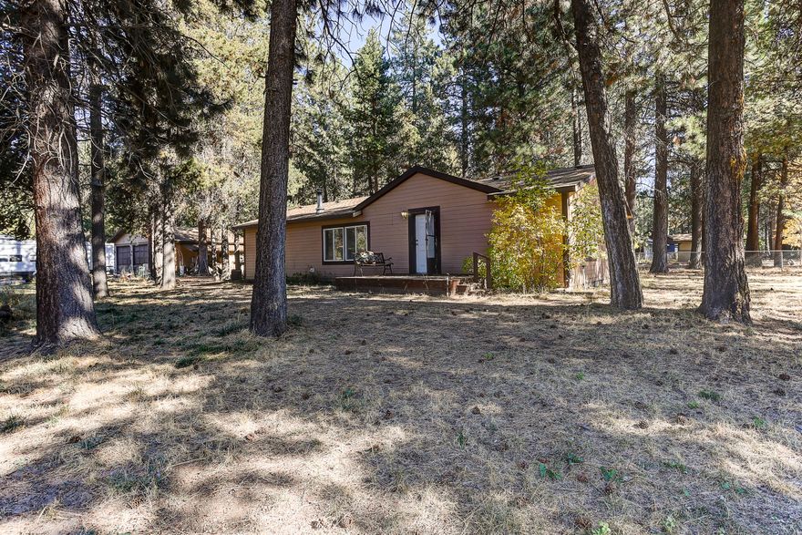 You can't beat this location, close to Mt Bachelor & Deschutes River! This 3 bedroom 2 bath 1404 sq ft home on just over a half of an acre, flat, fully fenced, corner lot, 30 x 30 shop w/ an additional full bathroom & room for RV parking. The home features a bonus room off of the laundry room, pantry, wood stove, new flooring in the bathrooms & a covered back patio. Call your favorite realtor today!