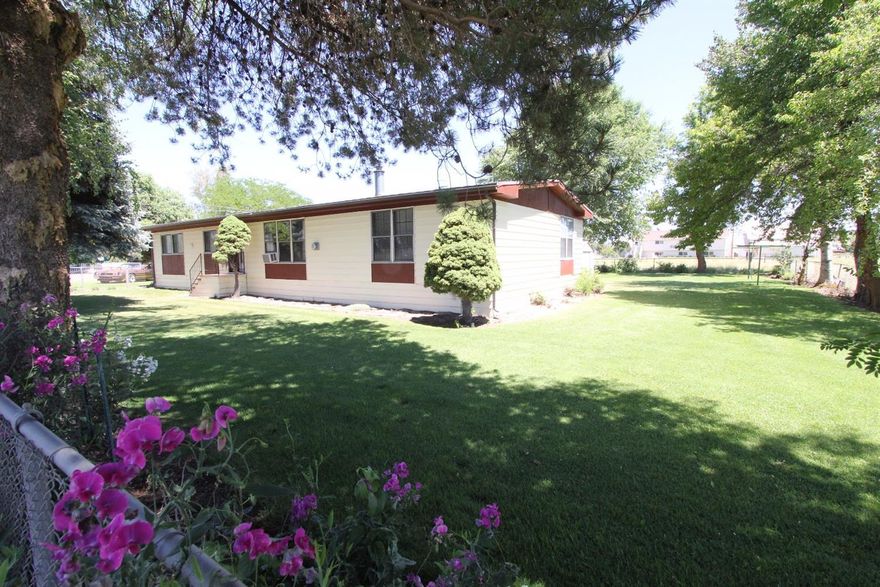 Meticulously maintained home with shop and shade trees. 3 bedroom 2 full bath home boasts 1848 square feet, a full wet bar and plenty of room for toys. Includes 30x20 detached 2 car garage, RV power hook ups for nearly any size RV, large garden shed with built floor. All three structures have easy to maintain metal roofs. Home offers open kitchen, vaulted living room, full wet bar connecting dining and living rooms, master with double vanity sinks, shower and soak tub. Homeowner loves the mature shade trees that keep home cool, beautiful lawn and small irrigated pasture. Come find out if this home is what you have been searching for.