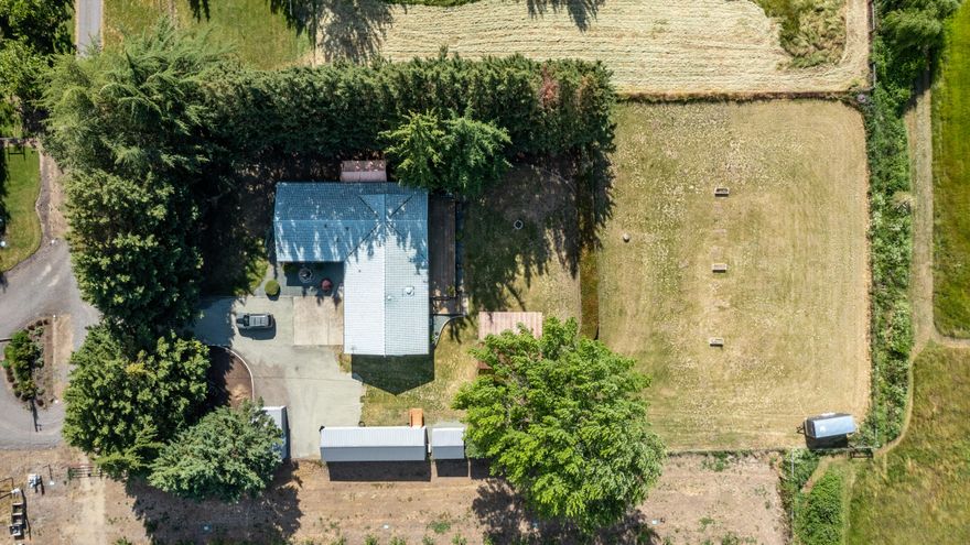 End of the road seclusion. All fenced and gated 1.1 acre on TID irrigated, flat usable land. Great views and privacy at this end of the road 1788 sq ft single  level home. 
Upgrades include granite counters, new stainless steel appliances, engineered flooring, new lighting & window coverings. 
New out buildings include a 12 X 40 Office / shop with 2 rooms and seperate AC / heat internet, a 12 x 12 storage / she shed plus a 12 x 20 Metal building with roll up door and man door and window. From the large deck a newly built 16 x 24 gazebo ready to fine tune for an outdoor kitchen or entertainment area. A new Generac whole house generator system is included. Move in ready.