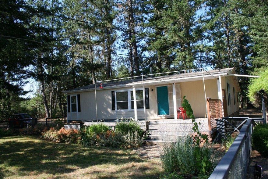 This is a really nice country property that is secluded and very quiet. The home is a double wide manufactured home with some additions. It has 3 bedrooms and 2 bathrooms, one of the bedrooms has had the closet removed but was being used as a bedroom. Has Range/Oven, refrigerator, W/D was It has two RV parking areas with full hook ups. It has a detached carport with a storage room attached. Has a detached shop that is finished. Has several other storage sheds and 2 pump houses. Has a really nice front yard that is fenced and has a sprinkler system, and it has a nice water feature. There is a nice sized fenced garden area. Has a chicken coop. It sits on a flat 5.22 acres with a nice mix of open areas and lots of tall pine trees. There are several water faucets for a good portion of the property. It has two wells that are good producers and just for security on of them has a 2000 gallon storage tank inside of the pump house. All information is deemed accurate but subject to change