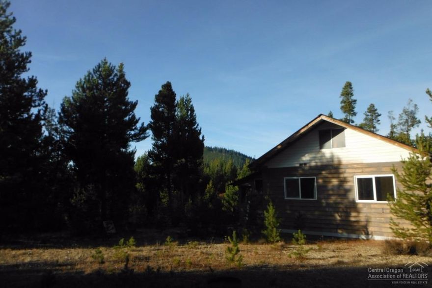 Are you looking for a fixer upper on an incredible piece of land with views? This may be it. Located on 3.93 acres in the Two Rivers North Neighborhood, this 2 bedroom, 2 bath home with tool shed, work shop, wood shed and garage is a work in progress. Views of the Butte, borders FS land, minutes from skiing, miles of snowmobile trails, fishing and hiking, and more. Rarely does a parcel like this become available. With well, septic and electric already in place, repair this home or build a new one!