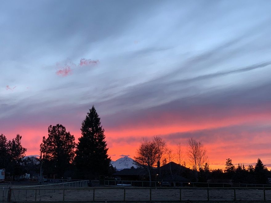 Welcome to your own little piece of paradise in Tumalo! This perfect little hobby farm is ready for all of your animals and
toys. Fully fenced with mature landscaping, a lovely pond and beautiful Cascade Mountain Views. Gated entrance at the
end of a private street just minutes to Tumalo and The Bite! The home is filled with natural light and features vaulted
ceilings and hardwood floors throughout the great room. Open concept with a large kitchen, living and dining areas.
Cozy sitting room looks out over the property and the mountains. Primary plus 2 bedrooms on the main with another
bedroom, bath and bonus room upstairs with a separate entrance. Large storage building with a full carport provides
lots of extra space. Fenced and cross fenced, hay storage as well as loafing sheds to keep the horses out of the elements,
chicken coop, fenced goat area and raised garden beds. Let your imagination run wild and make this your own!