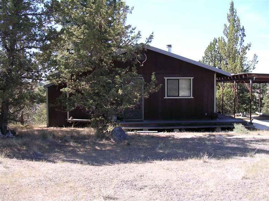 Imagine owning this rustic cabin in 3 Rivers Rec. Area. This rustic cabin sits on 5 acres. The work is all done for you. All you need to do is come play. Enjoy the private marine with access to Lake Billy Chinook, ATV/Dirtbike trails, gated community. Very motivated sellers.