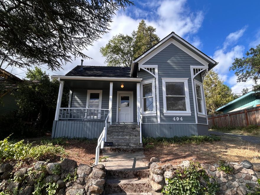 Sweet single level cottage from 1900 in a very desirable neighborhood in downtown Ashland! This home just had an exterior refresh with a new 30 year comp roof and gutters and freshly painted exterior. The interior is very much original and waiting for the next buyer to bring in new ideas to make this home their own! There is an additional bonus room not included in the square footage. Also, a detached one car garage and additional shed/storage. Love the large lot with mature trees, grapes and plums... if you can get them before the deer do. The property is zoned R-2 and per the city could accommodate an additional dwelling unit. Buyer to do their own due diligence.