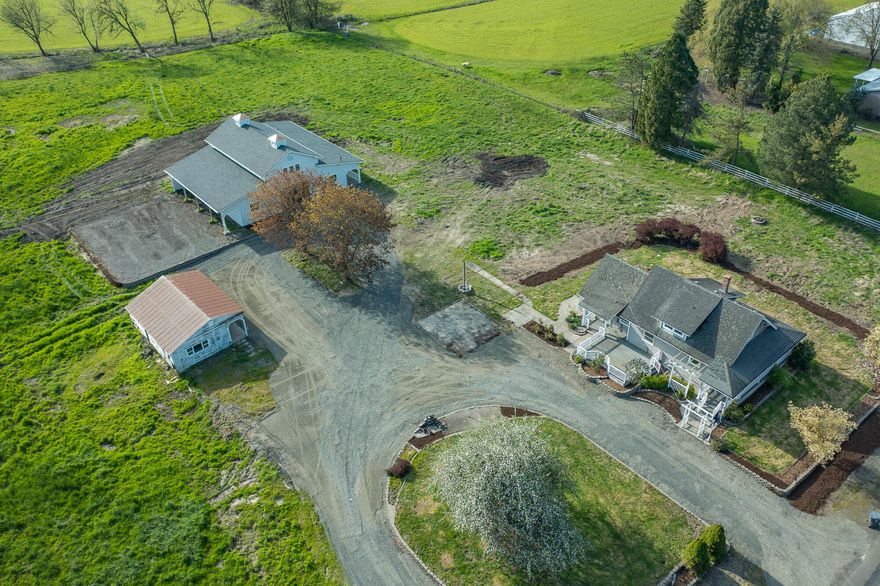 This picturesque 49.5-acre EFU-zoned farmstead features fenced pastures, a charming 3-bed farmhouse, a barn with stalls, all-weather turnouts, hay loft, a separate studio with office space, kitchen and a separate bunkhouse.   With 92% Class II soils, the farm ground could be easily converted into productive pasture for your horse facility or cattle operation.  This unique offering has a rare blend of rural charm and agricultural functionality, perfect for livestock, farming, or a home-based business. The property has ample hunting opportunities for game such as turkey, deer, pheasants and more. The land also features 3 seasonal creeks and slough access, making it an ideal habitat for wildlife!