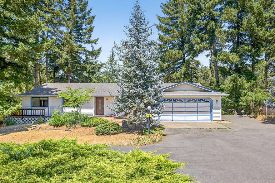 Escape to the peaceful serenity of rural country living in Grants Pass, Oregon with this charming ranch-style home nestled on 1.24 acres!  Built in 1989, this spacious 3-bedroom, 2.5 bath home offers 1,673 s/f of well-maintained living space with inviting open floor plan featuring vaulted ceiling, large windows that bring in natural light, and a cozy woodburning stove.  The generous kitchen offers a pantry, and accesses the dining area, making it ideal for family gatherings or entertaining guests.  The primary bedroom offers a peaceful retreat, complete with ensuite bathroom and plenty of closet space, plus two additional bedrooms and guest bath. Two-car attached garage plus a 3rd car garage for hobbyists needing extra room for projects, storage, or a home gym.  Fenced area for garden or small animals AND Fruit Trees (Apple, Oriental Pear, Rainbow Cherry, Persimmons & Walnut).  Conveniently located within minutes to town, shopping, hospital and schools, plus a Home Warranty!
