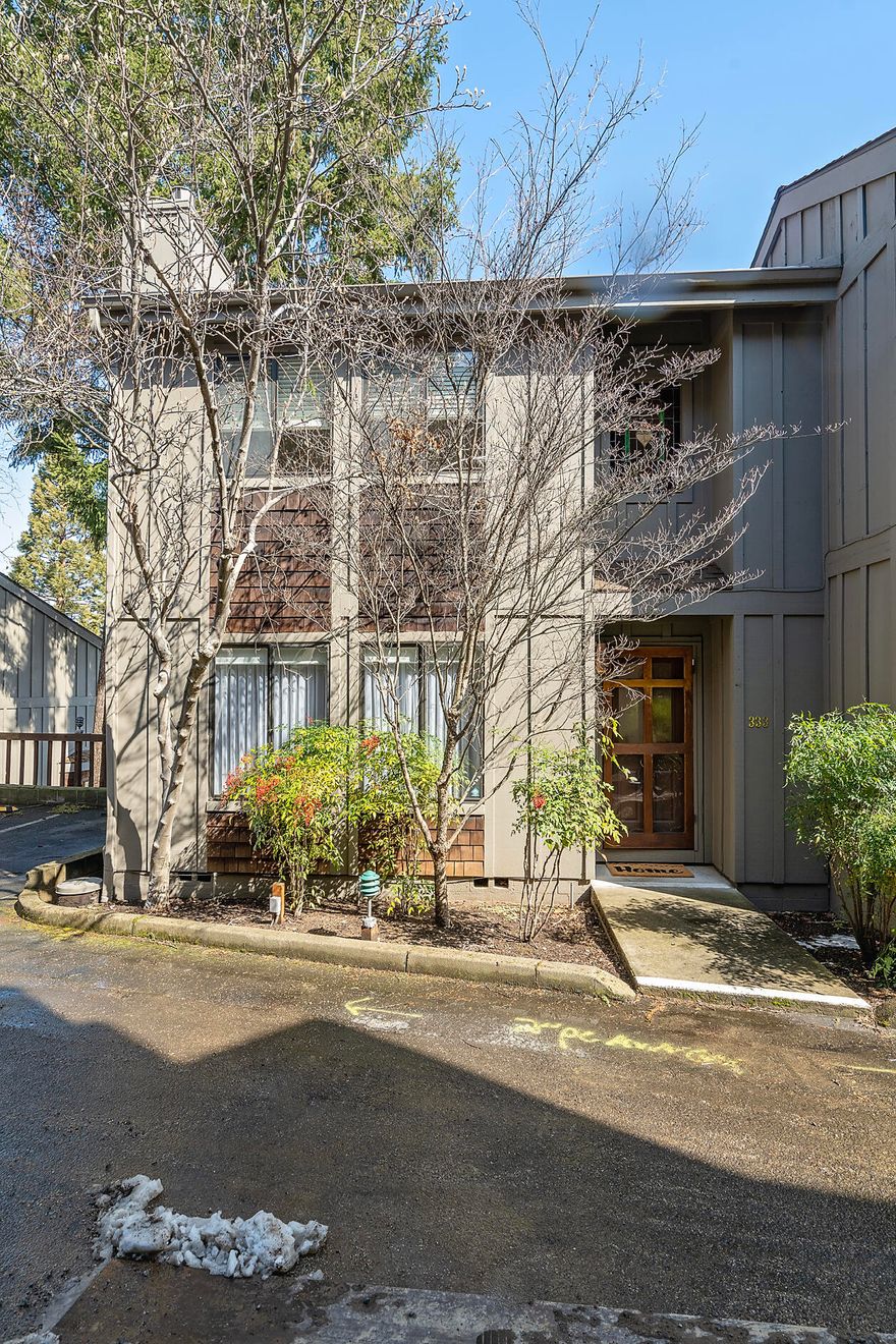 This incredible end unit townhome has abundant natural light. Located in a quiet neighborhood but close to downtown, the Oregon Shakespeare Festival, shopping and dining. This home has a gas fireplace, granite countertops and beautiful hardwood flooring. Enjoy the gorgeous views from the two private decks, including the one off the primary suite. Both bedrooms have vaulted ceilings and plenty of natural light. This home also has a stackable washer and dryer within the unit. There is an assigned parking space in a covered carport, and an additional storage room off the carport. The community also has a private outdoor pool. Come check out this amazing townhome today!