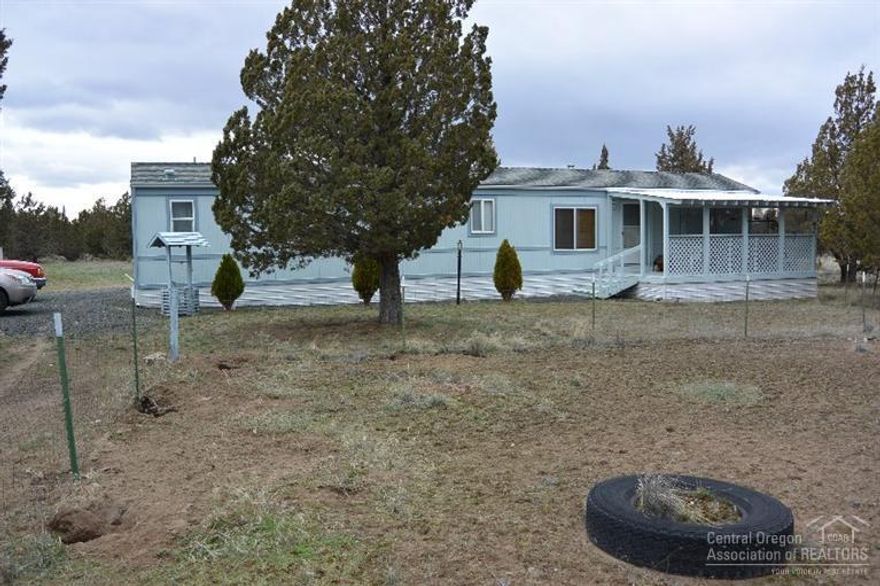 Quiet and private 4 acre retreat. Home features two bedrooms, two bathrooms, oil and electric heat, covered front and rear porches for outdoor living, detached two car carport, large storage building and an insulated pump house with storage space. The lot is flat and fenced and features many mature trees. Bring your RV, boat, toys, pets and livestock. Turn-key ready to move in. Just minutes from Prineville Lake!