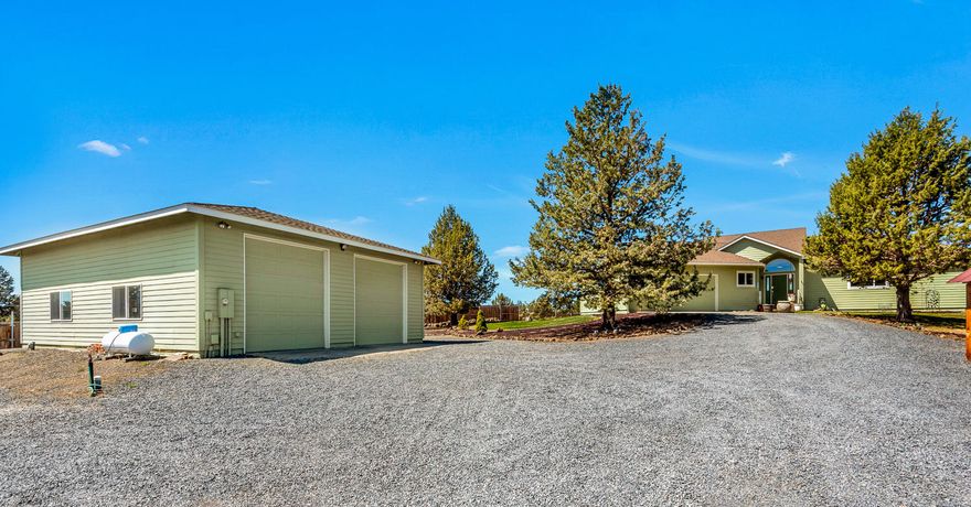 Immaculately maintained and thoughtfully designed, this private retreat is nestled on over 4 acres adjoining BLM land. Tall ceilings and large picture windows provide abundant natural light & peek-a-boo mountain views. The fully enclosed sunroom leads to full-length back deck, ideal for relaxing moments. Well-appointed kitchen features extra counter & storage space, stainless appliances & counter seating. Hardwood floors throughout w/radiant floor heating provide warmth in colder months while strategically place mini-splits cool in the summer. Primary suite features large walk-in closet & bath with dual-head shower. Two guest bedrooms, full bath, large laundry/mudroom & attached 2 car garage. Incredible, oversized 40'x30' insulated & finished shop with tall ceilings, two 11' roll up doors, concrete floor, enclosed office & loft storage adds flexibility & potential to this property. Deer fenced grounds & abundant parking complete the package. Nothis is missing here - except you!