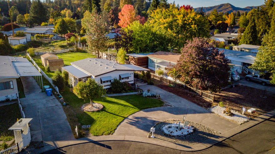 You will not want to miss this clean, comfy and super cute home! This two bedroom, one bath home has an updated kitchen and bathroom with easy step shower, covered front porch and newer roof. If you are looking to move to a 55 and over community but don't want to give up your space, look no further! This home has a HUGE backyard with four outbuildings with plenty of storage. All kitchen appliances, washer/dryer and electric fireplace in the living room are included in the sale. Call today for a showing! All potential buyers must be approved by park management (easy process.)