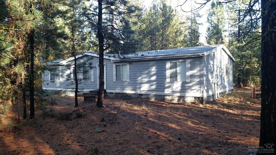 3 Bedroom 2 Bath Manufactured Home on 2.37 acres. Home was built in 2000 and is located in Ponderosa Pines. Lot is very well treed and has huge possibilities.