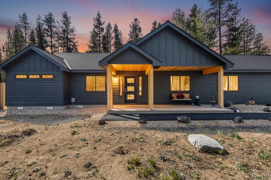 Discover your ideal Oregon retreat in this newly built contemporary PNW home on 1.26 serene, forested acres. This 2,185 sq. ft. single-level residence combines luxury and comfort with vaulted ceilings, wide hallways, and a sunlit great room. The chef's kitchen features stainless steel appliances, custom cabinetry, and an inviting eat-bar—perfect for entertaining family or guests. The primary suite offers a spa-inspired bath and walk-in shower, while two additional bedrooms and an office provide flexible space. Step outside to a covered patio and private hot tub amidst peaceful forest views. With an attached two-car garage, detached shop, and RV hookup, this home accommodates every lifestyle. Just 30 minutes from Bend and 40 to Mt. Bachelor, it's a turnkey escape for relocation buyers or a sophisticated vacation retreat.