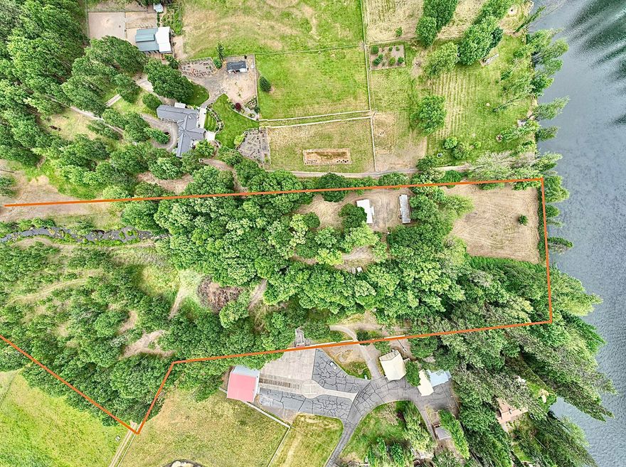 Prestigious 10.02-acre Rogue River Front property on Modoc Road with a year-round creek, a 1200 sq ft shop and a Mobile home with well, power and septic from the original construction of 1973. Zoned EFU with irrigation rights from the Rogue River. With a view of the Rogue River and a 128-acre natural land preservation from your front yard. Local to the Medford Airport for air travel. Come and build your dream home and live on the Rogue River. Enjoy your acreage of privacy, fishing and rafting on the Rogue River, hiking Table Rock, boating at Lake of the Woods and Lost Creek Lake. Additional private road access may be obtained. This property can also be purchased in conjunction with a connecting 10.89-acre and EFU-zoned land with irrigation rights (see listing for 12240 Modoc Road #B). Realtor must accompany all potential buyers for access. Buyer to perform due diligence for construction and use of the property.