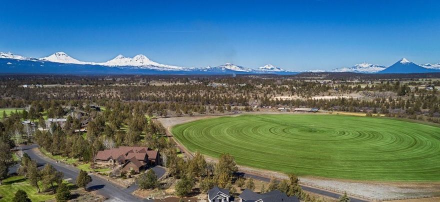Unobstructed Cascade Mountain, pastoral and river views from an award-winning custom home in Deschutes River Ranch. Situated on .56/acre, 10 minutes from Downtown Bend, this timeless Northwest Contemporary offers privacy, tranquility and unsurpassed craftsmanship throughout: Cedar beamed ceilings, wood wrapped windows and accents, 3 stone fireplaces and multiple outdoor spaces to enjoy. Chef's kitchen features solid surface counters, Wolf range, lg working island and opens to spacious, light-filled family rm overlooking the mountains and pastures. Entertain under the Central Oregon skies on the upper deck or in the formal dining rm w/more stunning views. Main level home office and formal living room. 2nd level: Primary Suite with spa-like bath and private deck + 2 add'l BR and full BA. Daylight basement: 4th BR, full BA and media rm w/access to patio, backyard and kitchenette. Private access to river, trails, fly fishing, swimming hole and 32,000 acres of public land.
