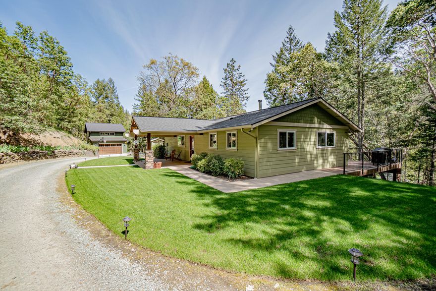 Meticulously maintained home in park-like setting on sought after Anderson Creek Rd. 7.25 very private acres with two creeks flowing through it. This 2780 square foot, 4
bedroom, 2.5 bath home is extensively remodeled, including a recent major kitchen renovation. Vertical grain Douglas fir cabinets, doors and trim throughout. Spacious
main level master bedroom. A beautiful high efficiency fireplace on the main level and a free-standing wood stove on the lower level offer a great source of backup heat to
the modern, energy efficient heat pump. A large, multi-level deck overlooking the creek and surrounding forest offers a great outdoor entertaining space and includes a
view out to Grizzly Peak.A beautiful detached oversized garage was built in 2019. It's wired for EV charging and has a 440 square foot finished space above with its own
full bathroom and mini-split heat pump. Great for guests, or possibly an ADU or artist's studio? 2 good producing wells.