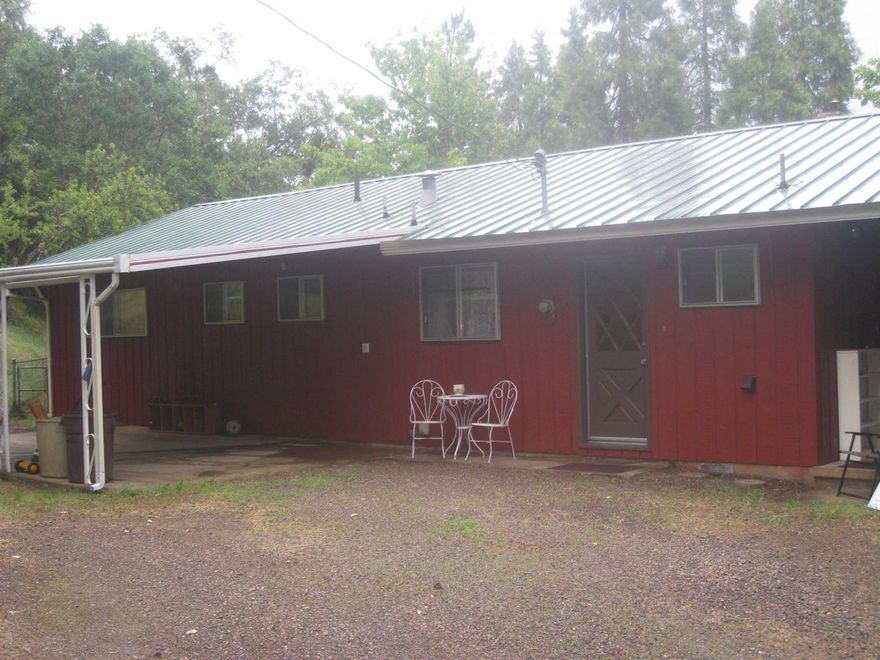 Quaint and charming Jacksonville home. Located a short distance to town, coffee shops, restaurants, Britt Festival Grounds and many other activities in this historical town. Nestled amongst mature trees and giving that comforting feel of nature at its best. Enjoy the local deer roaming, the sound of turkeys and birds offer peace and tranquility sitting on the covered deck while you enjoy the mountain views. The home sits on a large .42 acre lot that offers room to garden or work outside or you can leave the yard in a low maintenance natural state.