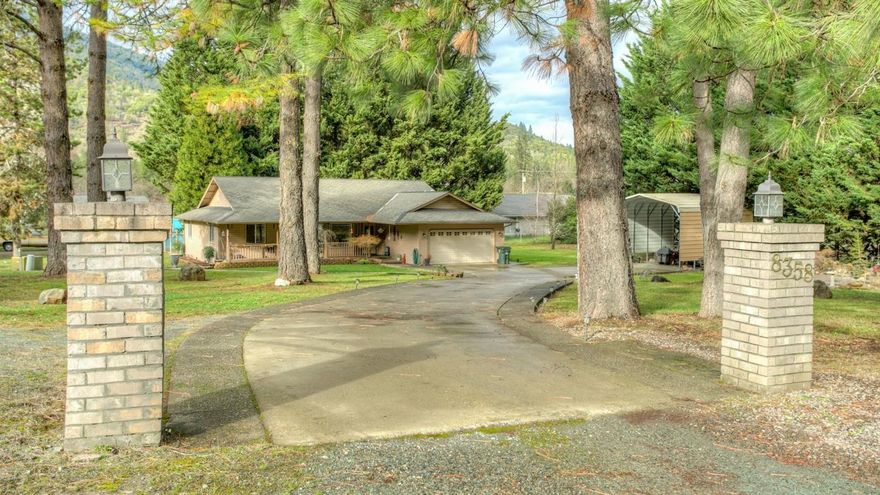 Beautiful setting in Rogue River on 1.01 park-like acres; close to Grants Pass and Medford. Featuring a custom built home with 3 bedrooms, 2 baths home in a spacious 1696 sf. A split bedroom floor plan, stainless steel appliances, arched doorways and coffered ceiling. The perfect home for entertaining family and friends. Open floor plan; living room has a bay window to enjoy the mountain views and beautiful trees. Private master suite with walk-in closet. French doors lead to covered patio; would be a wonderful spot for that morning cup of coffee. An attached garage; covered RV parking; concrete driveway; storage shed. Take a look at the virtual tour. Put this one on your list to see today.