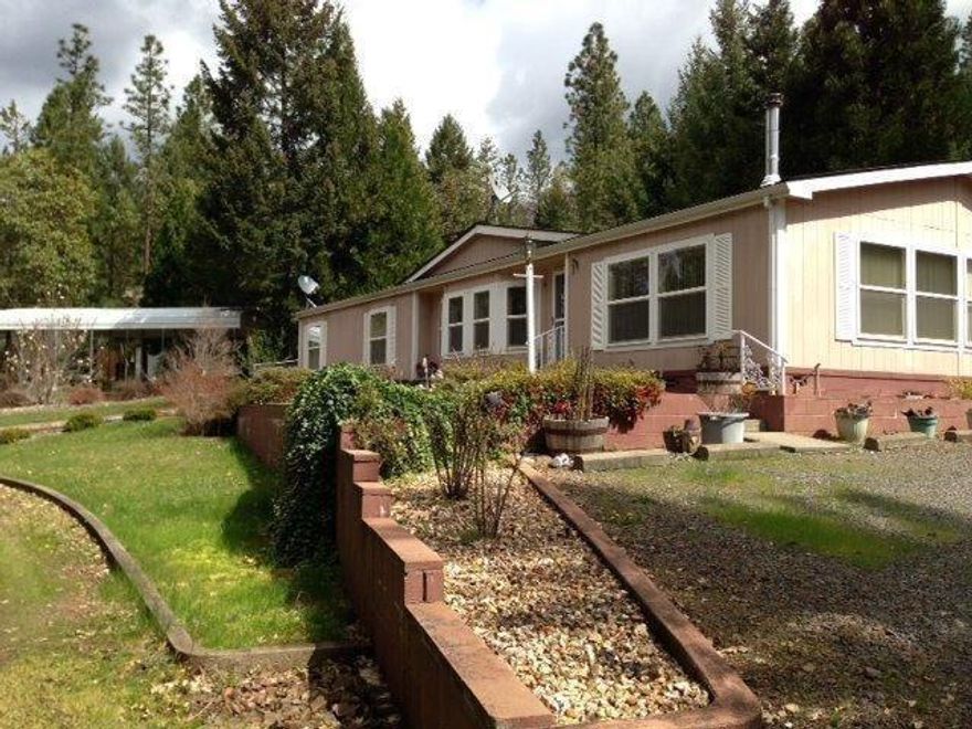 A little piece of Heaven! located just past the Wimer covered bridge on Sykes Creek rd. This 2.68 acres of land is completely fenced and well taken care of. The home is a 3 bedroom, 2 full baths, vaulted ceilings, open kitchen with plenty of storage throughout. 3 huge metal awnings for extra covered parking, one which is a RV cover with hook-ups! One of the storage buildings could be used as guest quarters! Please see agent remarks.. CASH OR CONVENTIONAL ONLY!