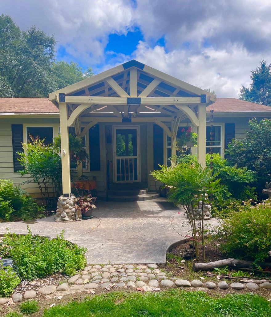 The sweetest little homestead on Pass Creek.  Enjoy solitude of sitting areas overlooking creek, enjoying sights and sounds and smells of gardens including water features.   Fenced vegetable garden includes, berries, plum, pear, apple and peach trees.   
Large deck with pergola for gathering.  Multiple fenced pens, barn and hay barn.  New roof coming July 7.  Fireplace is propane in family room and this craft area also has sink and microwave.    Sellers needs to locate replacement home.