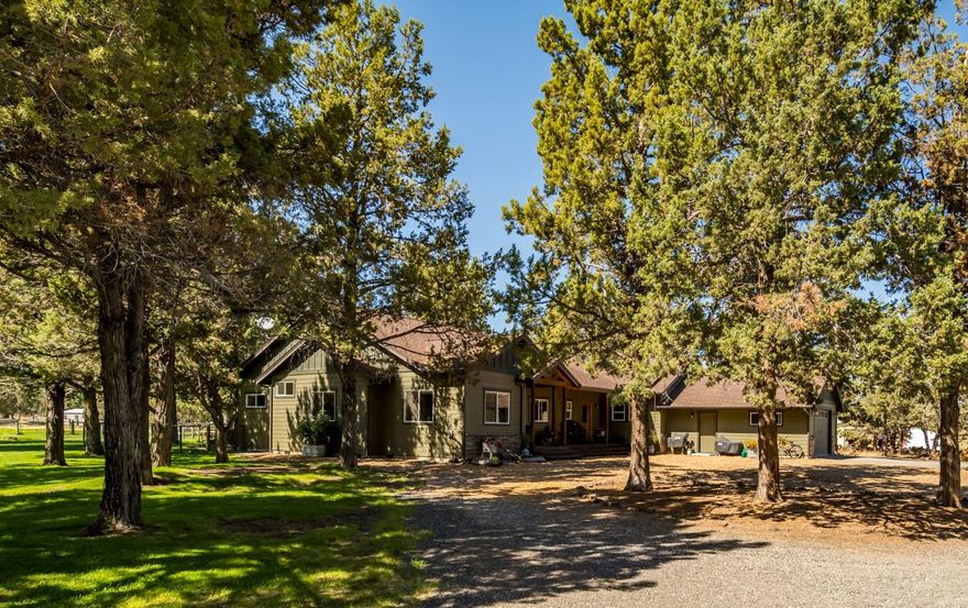 This Custom-built single-level home on 6.4 acres with 3 acres of irrigated pasture, offers beautiful wood accents in a cozy setting. The living room features custom built-in book shelves, gas fireplace, and charming wood-covered ceiling. Perfect for horse enthusiasts, the property includes horse stalls, a tack room, separate hay storage, and expansive pastures. The modern kitchen boasts stainless steel appliances, large island with built-in sink and an ample pantry. The primary bedroom has a door to the back deck, surrounded by beautiful landscaping and peekaboo mountain views. House is wired for sound w/ speakers on the back deck and dining area. Additional highlights include: functional mudroom, workshop in the garage, and a gorgeous back patio with built-in fire pit overlooking the pasture. Nestled in a serene location, this move-in-ready home combines comfort, style, and privacy, just a few miles from the east side of town. Schedule your private tour today!