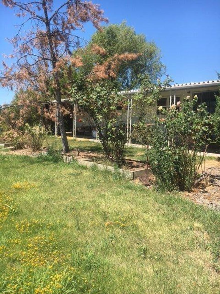 Beautiful piece of land in a fantastic, central location. Nearly 3/4 of an acre offers a complete sprinkler system for irrigation, a small pasture for a couple horses, small livestock or a large garden. Beautiful, mature willow trees in place to provide the utmost privacy and peace. Replace the current mobile home with your dream house and enjoy country living at its finest!