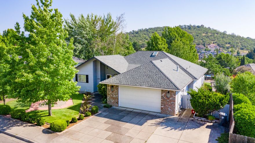 Well designed single level home on a large lot in a quiet, well established East Medford neighborhood. Great curb appeal with beautiful mature landscaped front yard. Covered front porch leads to a spacious Brazilian granite entryway. Living room has coffered ceilings, a double sided gas fireplace and large windows to enjoy the views and capture natural light. Large kitchen open to the dining area has Italian tile, newer stainless steel appliances and great countertop work space. Slider leads out to a large deck overlooking the beautiful backyard with Koi Pond, patios various mature plantings and expansive views of the mountains afar. Great separation of the bedrooms, master bedroom suite on one side with soaking tub, shower, dual vanities and walk-in closet. Two additional bedrooms and a shared bathroom are on the other side of the home. Lots of storage space! This is a great house awaiting your personal touches!