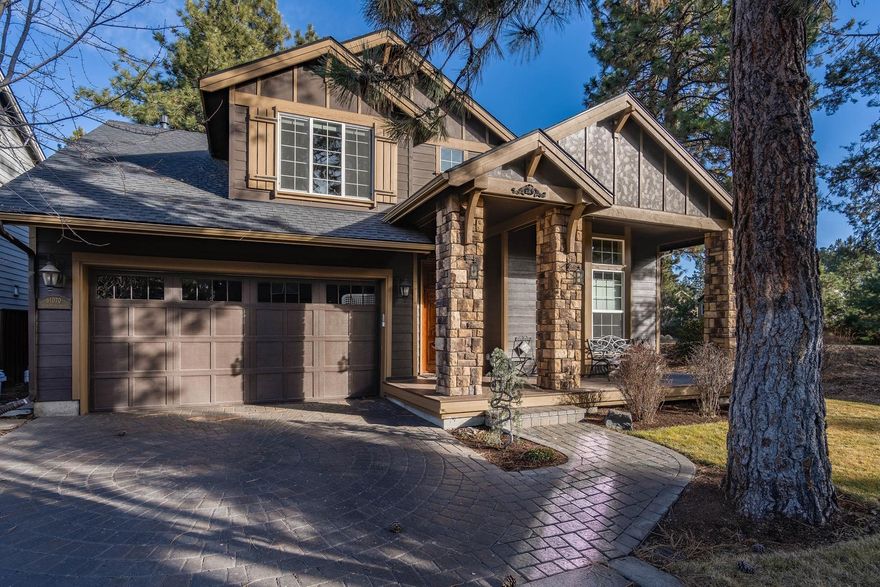 Tucked back into the corner of a private lane in River Canyon Estates, this two-level home boasts a location that is hard to beat. Enjoy an open family room and kitchen, as well as a separate living room and dining room for more formal occasions. In the kitchen, find granite slab counters, a built-in desk, and a breakfast bar. One of the four bedrooms and a bathroom are also on this level. Upstairs, the well-appointed owner's suite features a luxurious en suite bathroom with free-standing soaker tub and walk-in tile shower, as well as access to the walk-in closet. Also on this level are a small office, 2 guest bedrooms, a guest bathroom, and a laundry room. Other features of this home include a two-car garage with epoxy floor, backyard with mature pine trees and a patio, and a covered front porch. Residents of River Canyon Estates enjoy a community pool and fitness center, as well as easy access to the Deschutes River and canal trail.