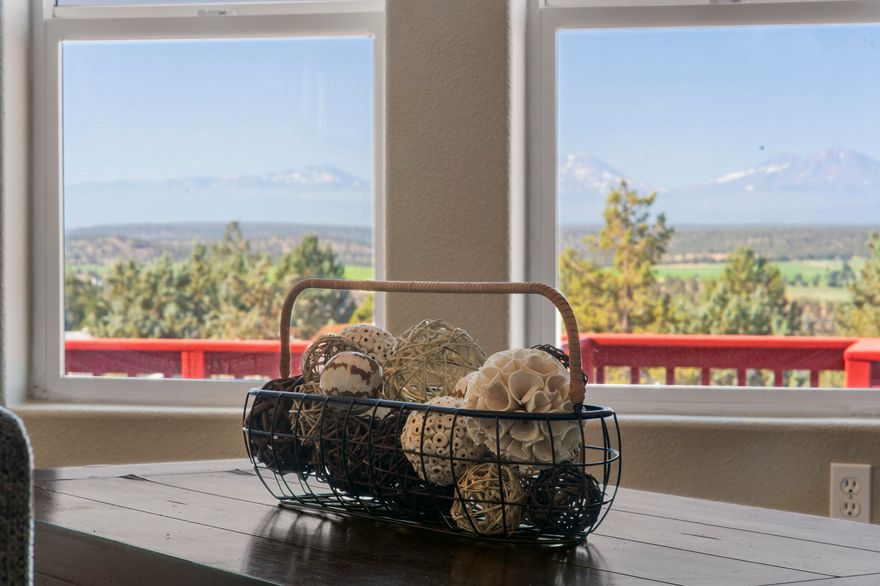 PANORAMIC VIEWS from this freshly renovated 1,700+sqft home! Interior space is light and bright, w/ a wall of windows facing the Cascade Mountain range. Separated floor plan provides privacy, and includes 3 bd, 2 ba, PLUS den! Spacious primary suite has private access, soaking tub, and ample closet space. Den is perfect for a media room, home office, or library. Kitchen features solid surface counters, butcher block island, counter-to-cabinet tile backsplash, and SS appliances. Cozy up to the wood stove in winter and entertain with a breathtaking backdrop on the expansive deck in the summer. Updates include LVP flooring throughout, paint inside & out, new fixtures, windows, PEX plumbing & more! Detached, finished two-car garage has a heated studio space with a 1/2 bath! Huge RV garage below has power and 14ft roll-up door. Property has been cleared of brush, rock-scaped for low maintenance, and partially fenced for your animals. You will simply have to see this property to believe it!