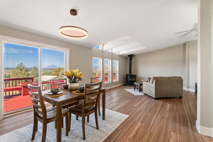 UNBEATABLE VIEWS from this freshly renovated 1,700+sqft home! Interior space is light and bright, w/ a wall of windows facing the Cascade Mountain range. Separated floor plan includes 3 bd, 2 ba, plus den. Spacious primary suite has private access, soaking tub, and ample closet space. Den is perfect for a media room, home office, or library. Kitchen features solid surface counters, butcher block island, counter-to-cabinet tile backsplash, and SS appliances. Cozy up to the wood stove in winter and entertain with a breathtaking backdrop on the expansive deck in the summer. Updates include LVP flooring throughout, paint inside & out, new fixtures, windows, PEX plumbing & more! Detached, finished two-car garage has a heated studio space with a 1/2 bath! Huge RV garage below has power and 14ft roll-up door. Property has been cleared of brush, rock-scaped for low maintenance, and partially fenced for your animals. You will simply have to see this property to believe it!