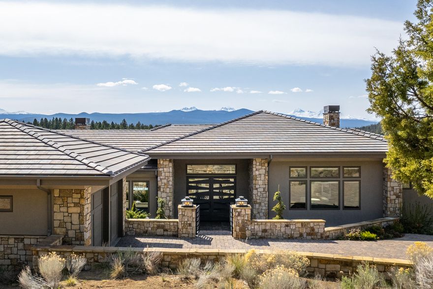 Situated on the NW Side of Awbrey Butte is this home of modern and elegant design. You will fall in love from the minute you enter and are greeted with unobstructed views from Mt. Bachelor to Mt. Hood. The use of tiles, stones and textures are spectacular! A huge granite stone art piece above the f/p in the great room & the wall of Carrera marble w/ mother of pearl in the primary bath are like no other. The grand kitchen offers a timeless and innovative style with custom cabinetry & incredible organizational options w/ premium Miele appliances complete with 8-burner range, dbl ovens & built-in coffee+ machine. The focal point of kitchen is the waterfall edge, solid granite center island. The laundry/mud room has access to the butler's pantry and exits to the patio which leads to the garage. Behind the oversized 2 car garage is a multi-use room.  Could be used as an art rm, guest rm or office.  Enjoy Mt. views from most of the rooms & from the expansive deck.