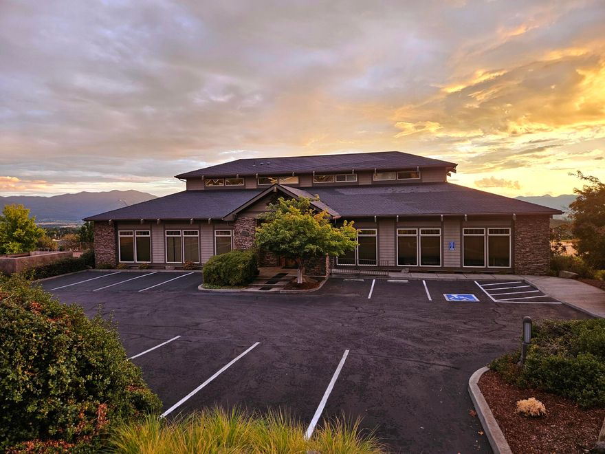 4497 Brownridge Terrace is an extremely nice two-level office building in Medford, home base for a variety of professional businesses. The building is part of the Vista Pointe residential development established in 2007. This special contemporary building offers ten office spaces and sits on a 21,780 sq ft half-acre lot. Many offices offer outstanding views of the Rogue Valley and its surrounding landscape.  The flex-style office space offers a variety of modern workspace options, including individual and co-working spaces, with flexible terms and amenities. The main entry has beautiful hard wood flooring, an open reception area, with two separate restrooms. Parking and entry camera surveillance (3) and maintenance systems are in place. A total of twenty parking spaces accommodate tenant and guest parking.