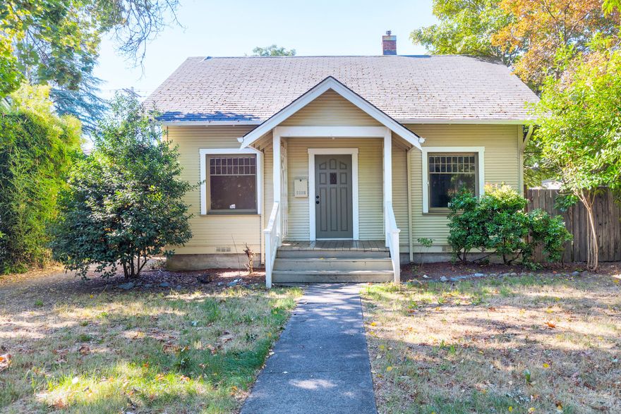 Step into 1928 character with this 3 bedroom, 1 bath home in the heart of Grants Pass. At 936 square feet, this home features hardwood floors, a clawfoot tub, and a covered patio for year-round enjoyment. The fenced yard has room for garden boxes or pets, while the detached garage, workshop area, and alley access provide extra parking and utility. Located near downtown and Grants Pass High School, this property offers a rare mix of classic charm and everyday convenience, perfect for first-time Buyers, Downsizers, or Investors. Do not miss your chance to own a little piece of history in NW Grants Pass.