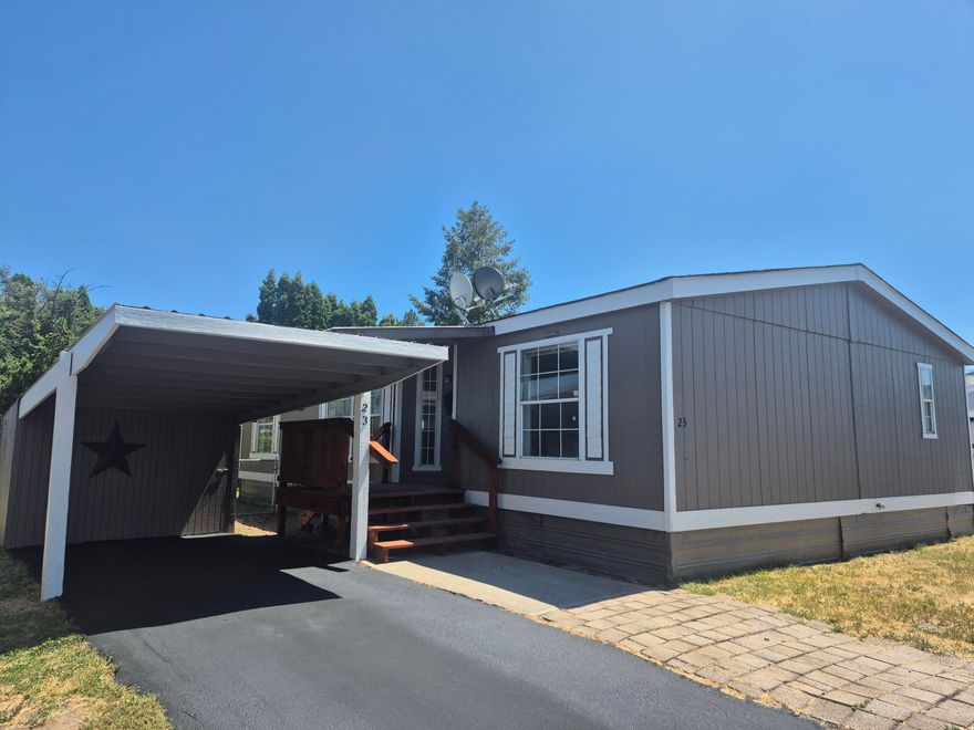 Enjoy this spacious 3 bedroom, 2 bath home in a senior community, conveniently located close to downtown. Many recent updates include fresh new paint, inside and out.  new trim throughout, new floors in the bedrooms and bathrooms, new tile countertops and covered front deck. This home features a large open living space, perfect for relaxing or entertaining. Comfortable living situated in a friendly neighborhood. Seller is offering $10,000 in seller credits.