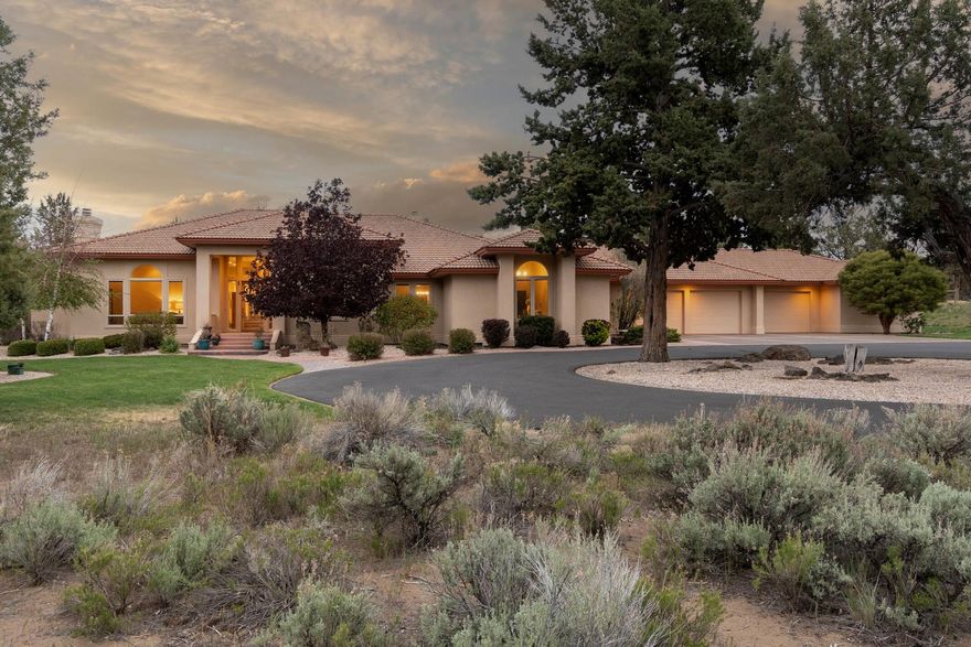 Luxury living in the country. Peaceful, gated, fully fenced acreage offers gardening, hobby farming or equestrian options. Grand tile entry reveals soaring ceilings and their meticulous designs. 
Entertain in nature on covered and lower-level patio as dining and ''nook'' areas access directly via oversized and ''French Door'' sliders.
Large, chef's kitchen w/ gas cooktop and loads of storage opens to immense great room, exposed-beam accent, central wood stove, completed with built-in wet bar and storage.
Well-appointed primary suite has sitting area with window surround, boasts oversized shower, jetted soaking tub, dual vanities and large divided walk-in closet. 
Massive 1,830 sf garage houses built in storage, 3 deep garage bays and bonus workout/hobby rm in finished would-be 4th bay.
Farm Amenities: barn w/turnout, riding arena, auto field irrigation, fenced goat pen adjacent to pasture, 1 acre deer-fenced orchard w/ fruit trees, direct access to upwards of 30k acres BLM land.