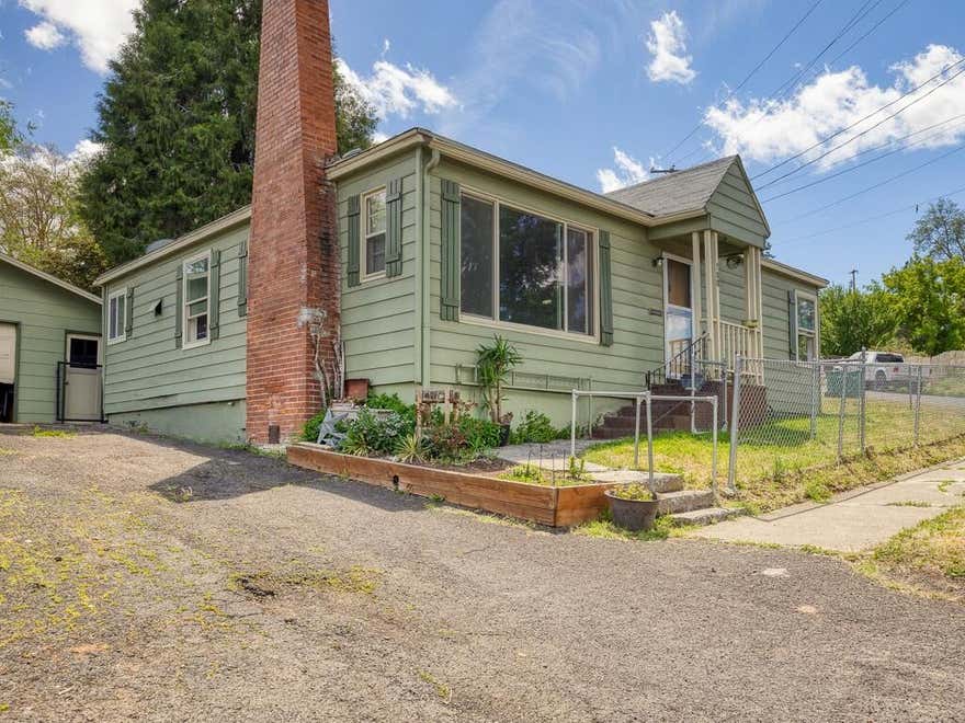 Welcome to this striking 1940's home, a delightful blend of vintage character and modern comfort. This cozy property offers 3-bedrooms, 1-bathroom, 2 car garage, and a fully fenced corner lot. Upon stepping inside you will find original hardwood floors that have been lovingly maintained, plenty of natural light spilling into the living area, a wood burning fireplace, lovely tile shower/bathtub combo, and fresh interior paint. 
Outside enjoy the evenings on the large private back patio, or spend some time in the sun while you utilize the spacious yard for gardening or relaxation. Call today, your dream home is closer than you think.