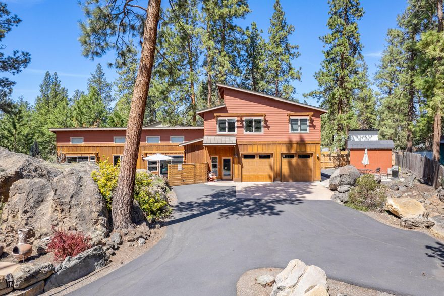 Nestled 150 yards from the stunning Deschutes River and its scenic trail access, this custom home offers an unparalleled location. Enjoy the convenience of being near the Old Mill's vibrant scene, including amphitheater concerts, restaurants, and shops. Ideal for owners, investors, or multi-generational households, the 4bd/3.5ba main residence features separate living spaces upstairs & downstairs, ensuring privacy and flexibility. High ceilings and ample south-facing windows flood the interiors with natural light. The property includes an additional detached 1bd/1ba 535 sf ADU, bringing the total livable space to 2,805 sf.  The ADU is currently a thriving short term rental generating approx. $47,000/year. The property's standout feature is a massive natural rock formation with a custom-built water feature, creating a beautiful and private outdoor oasis perfect for relaxation and entertaining. Additional highlights: oversized garage, exterior RV/van parking, and separate outdoor areas.