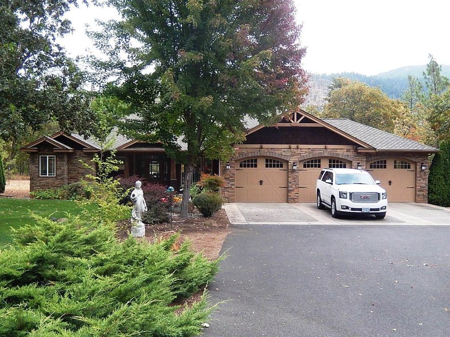 Exquisite Custom Home in quiet, pristine neighborhood of similar homes. This 2-Acre Home site offers lush landscape & trees. Formal Living & Dining Rooms, Family Room with Gas-Burning Fireplace & French Door leading to the Covered Deck & Stamped Concrete Patio. Back yard is pet and child safe with security fencing. In-Ground Sprinklers plus Drip. 4 Bedrooms & 3 Baths. Beautiful Hand-Scraped Oak Flooring in Living, Dining & Family Rooms. Gourmet Kitchen has Center Island, Granite Counter tops & all High-End Jenn Air Stainless Appliances, Gas Cooktop & Large Pantry. Custom Tiled Counter tops & Floors in Baths. Large Master Suite includes a sitting area w/ access to covered deck through French Doors. 2 Walk-In Closets. Adjoining Bath has Double Vanity, Private WC, Deep Soaking Tub & Separate Shower with Dual Showerheads. Attached 3-Car Finished Garage, Plus Detached Oversized Double Garage/Shop. Circular Drive is Black-Topped. No expense or quality accent has been overlooked! Great Well.