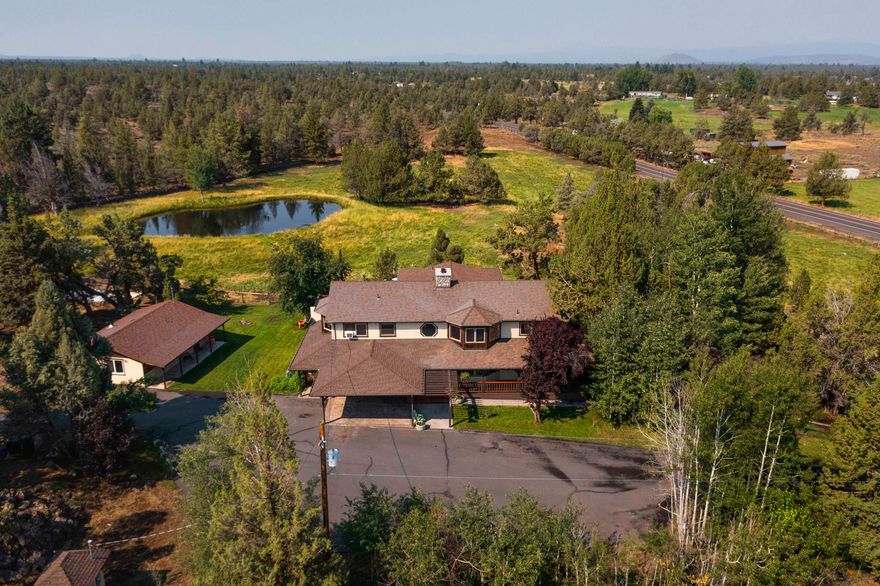 You enter through a private gate and drive up a tree lined drive to a beautiful Northwest 2 story farm style home. You will find 2 roomy bedrooms on the first level along with large office space, open family room and laundry room. Bamboo floors and a custom log stairway leads to the second level for reverse living floor plan. On the second level is the master bedroom suite with sauna, a chef's kitchen and living room with wood beam ceilings and access to the large wrap around deck. There is plenty room on the deck for summer BBQ's while enjoying great views on the pond, pasture and mountains. Please do not miss the 748 sq ft ADU. It has a full kitchen, living area and bedroom w/walk in closet. The possibilities are unlimited. This home is on 8 acres with 6 acres of COI irrigation.